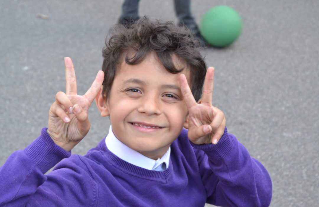 boy doing peace signs