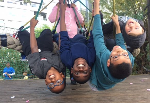 four boys hanging upside-down