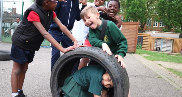 adventurers playing with a tyre