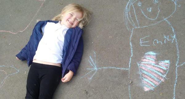 girl lying next to chalk person